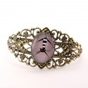 Bracelet chat noir et blanc sur fond gris